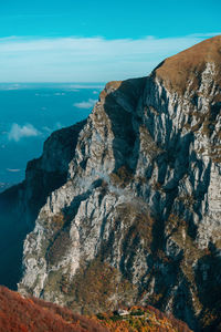 Rock formations by sea against sky