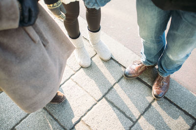 Low section of people standing on footpath