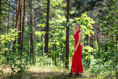 Portrait of woman standing in forest