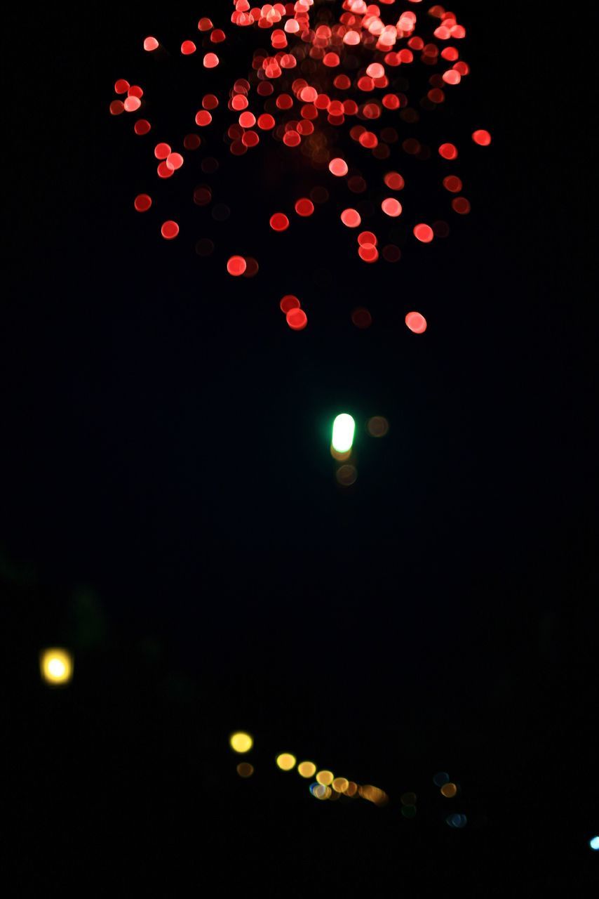 illuminated, night, red, celebration, lighting equipment, low angle view, dark, glowing, decoration, light, sky, no people, light - natural phenomenon, christmas, outdoors, copy space, celebration event, hanging, beauty in nature, multi colored