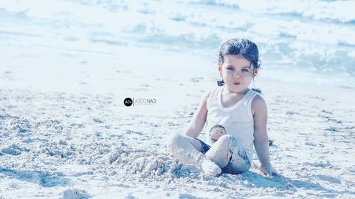 Portrait of happy girl sitting on land