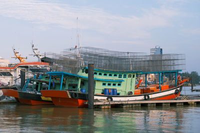 Boats moored in sea against sky