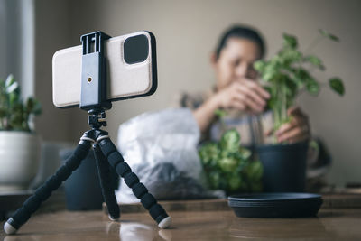 Woman vlogging about potted plants