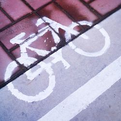 High angle view of arrow sign on street