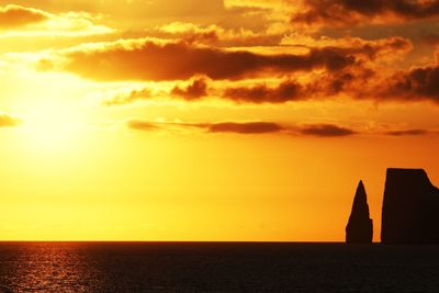 Scenic view of sea against orange sky during sunset