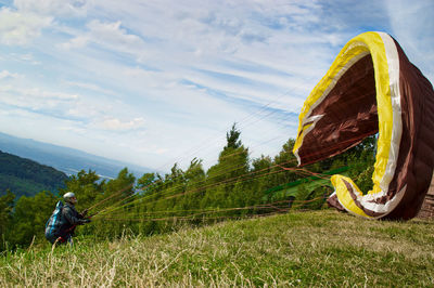 People on land against sky