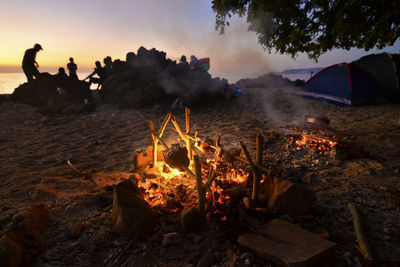 Scenic view of bonfire against sky at sunset