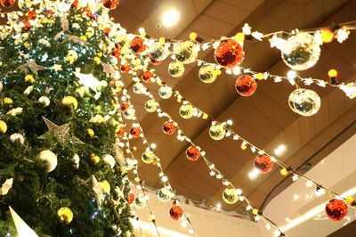 Low angle view of illuminated christmas lights hanging on ceiling