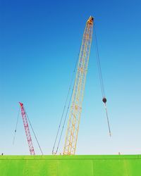 Low angle view of windmill against blue sky