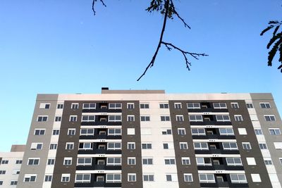 Low angle view of building against clear blue sky