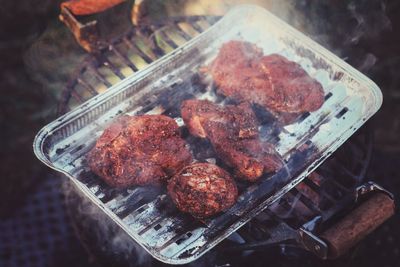 High angle view of meat on barbecue grill