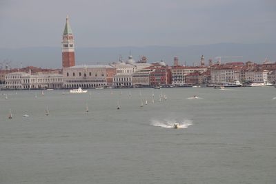 View of sea and buildings against sky