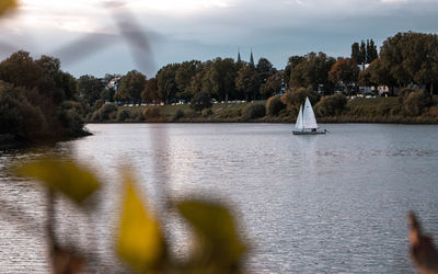 Sailboat on river with some depth of field in fall