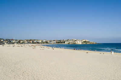 Scenic view of beach against blue sky