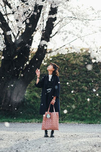 Full length of woman standing in park