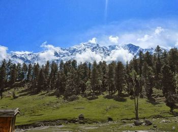 Scenic view of mountains against cloudy sky