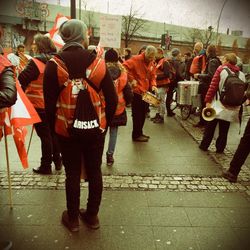 People on street in front of city