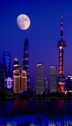 Low angle view of illuminated buildings against sky at night