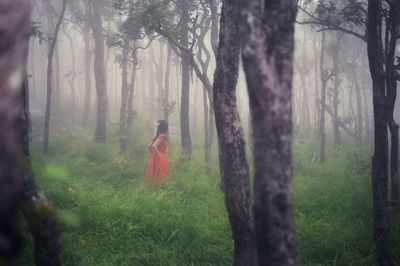 Woman standing in forest