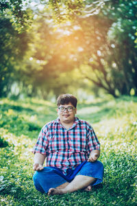 Portrait of man sitting on field