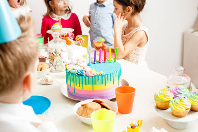 Midsection of people having cake