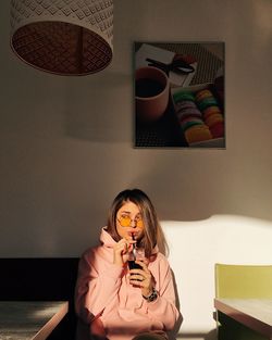 Young woman using mobile phone at home