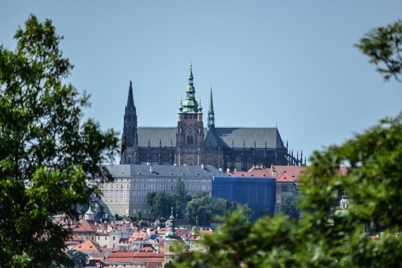 architecture, built structure, building exterior, tree, sky, plant, building, city, nature, clear sky, religion, place of worship, belief, day, no people, spirituality, tower, travel destinations, outdoors, blue, spire