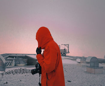 Rear view of man photographing camera