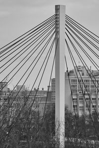 Low angle view of suspension bridge against sky