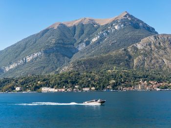 Scenic view of sea and mountains against clear sky