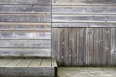 Closed wooden door of weathered wall