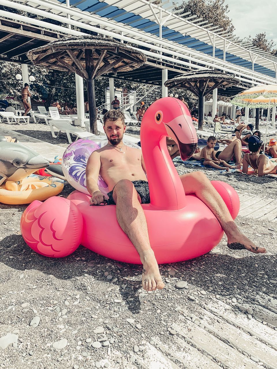 WOMAN WITH TOY SITTING ON PINK SEAT