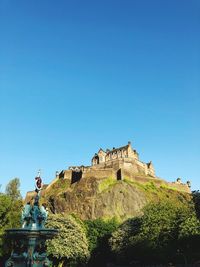 Low angle view of fort against blue sky