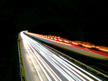 High angle view of light trails on highway at night