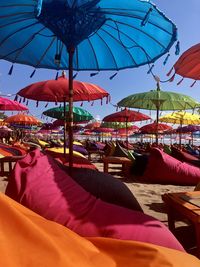 Umbrellas on beach against sky