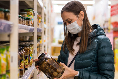 Woman wearing mask shopping at supermarket