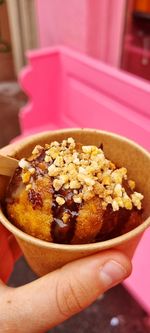 Close-up of hand holding ice cream