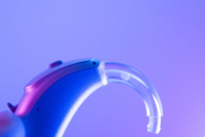 Close-up of illuminated light against blue background