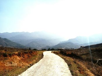 Country road leading towards mountains