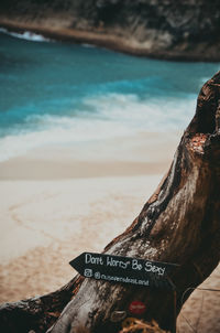 Text on beach against sky