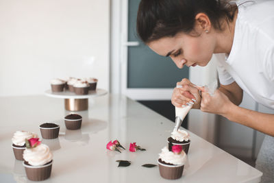 Woman making cupcakes at home