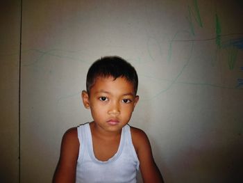 Portrait of boy against wall