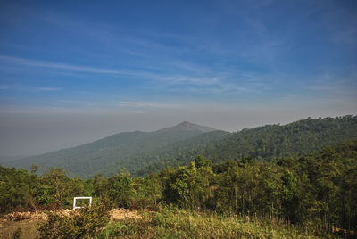 Scenic view of mountains against blue sky