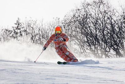 Person skiing on snow against sky