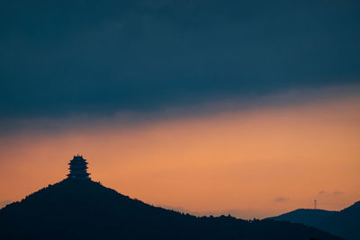 Scenic view of silhouette mountains against sky during sunset