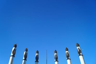 Low angle view of historic statue against clear blue sky