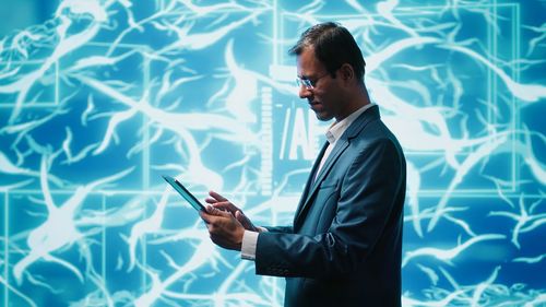 Side view of businessman using mobile phone