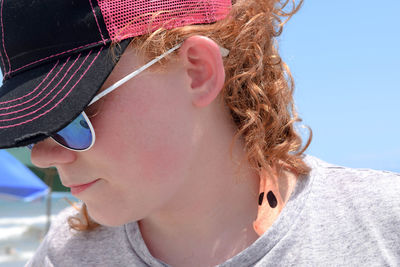 Close-up of woman wearing sunglasses and cap on sunny day