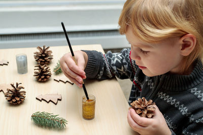Portrait of boy holding ice cream on table