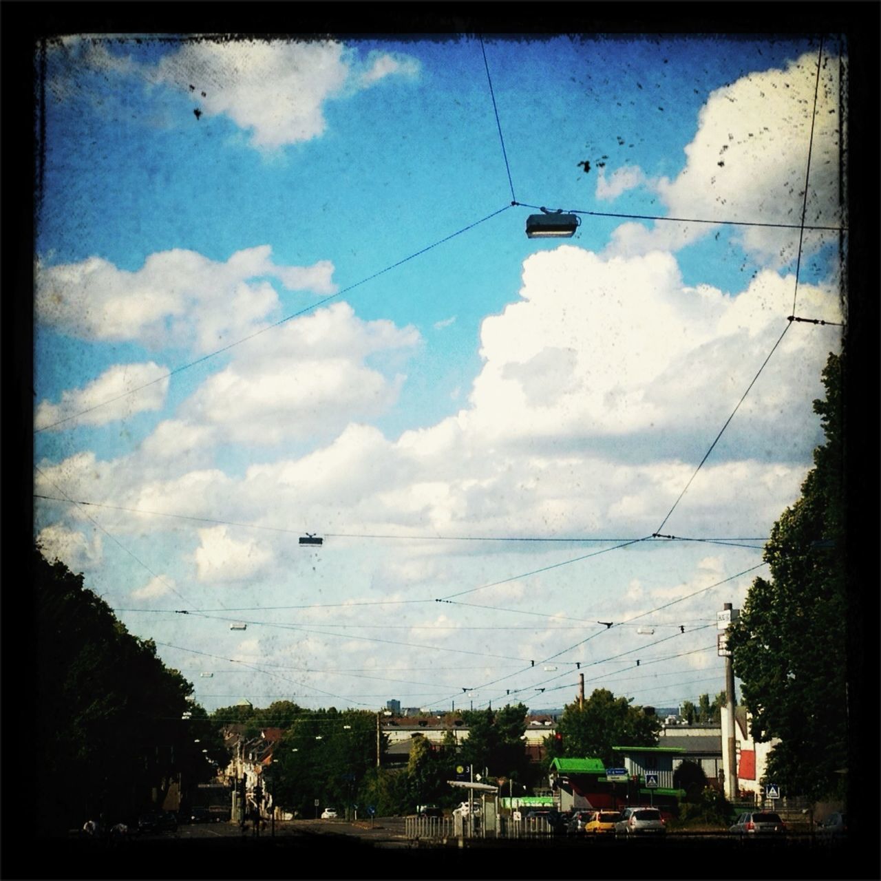 power line, electricity pylon, sky, electricity, transportation, power supply, cloud - sky, cable, fuel and power generation, mode of transport, transfer print, building exterior, cloud, built structure, connection, technology, cloudy, auto post production filter, power cable, architecture